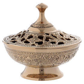 Burning incense with decorations and floral carvings in golden brass