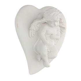 Resin angel statue lying on heart