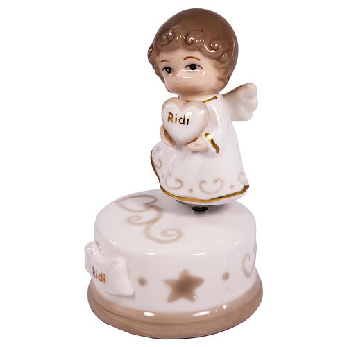 Porcelain angel-shaped music box, religious favour, h 5 in 2