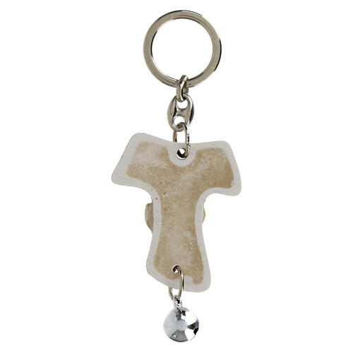 Tau-shaped keychain with Confirmation symbols and white bell, resin, h 5 in 2