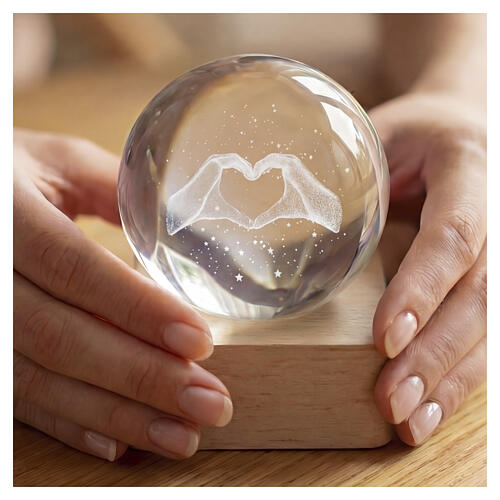 Crystal sphere with hands forming heart, square base 6 cm 3