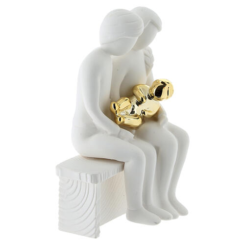 Seated family with golden infant, resin, 4x4 in 2