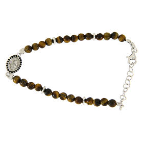 Bracelet with medalet, black zircons and tiger's eye beads