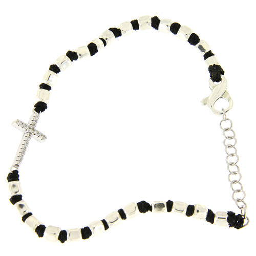 Bracelet with multifaceted silver beads sized 2 mm on a black cotton cord and a white zirconate cross 1