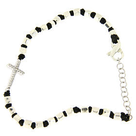 Bracelet with multifaceted silver beads sized 2 mm on a black cotton cord and a white zirconate cross