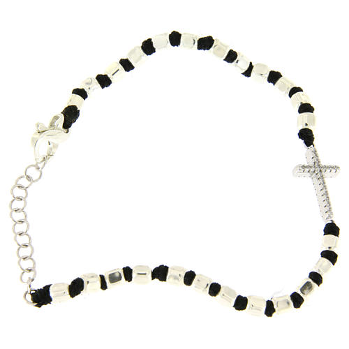 Bracelet with multifaceted silver beads sized 2 mm on a black cotton cord and a white zirconate cross 2