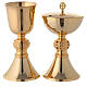 Brass chalice and ciborium with red stones on the node s1