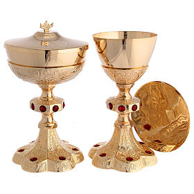 Chalice ciborium and paten with bas-reliefs and red stones, gold plated brass