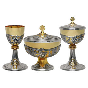 Bicolour chalice and ciboria, hand‑chiseled with grapes and wheat ears