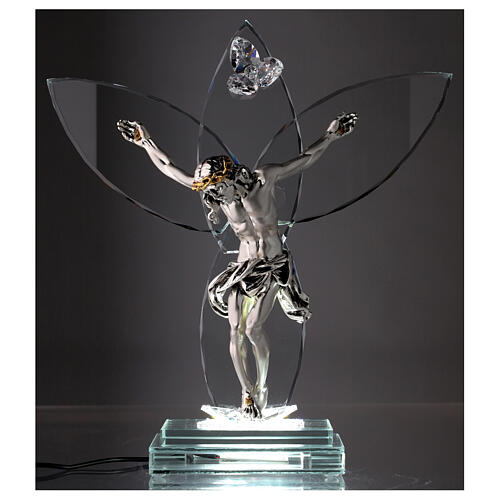 Crucifix in glass with metal body of Christ and light 2