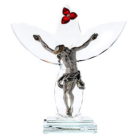 Glaskruzifix mit roter Blume und Lampe
