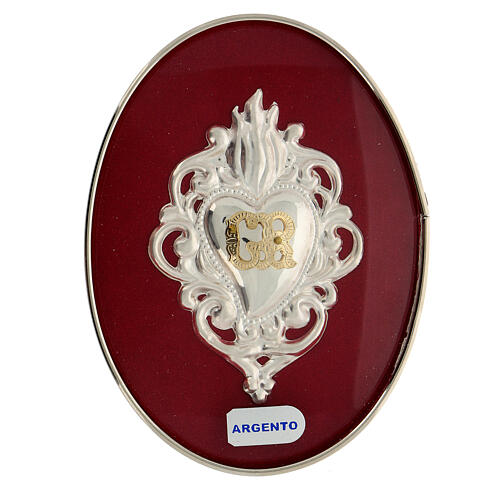 Ex-voto silver heart with flames and GR letters on a frame 1