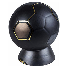 Soccer ball-shaped funeral urn, black and gold, with display base