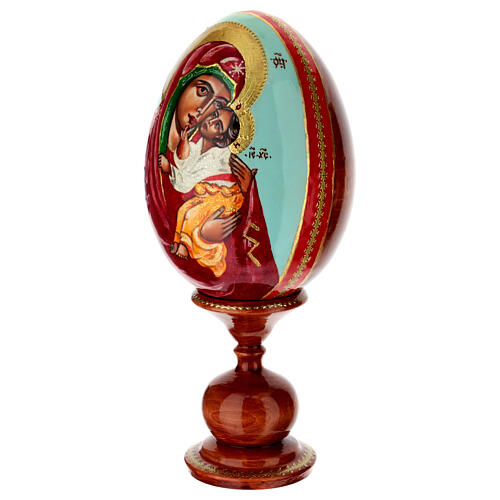 Painted wooden egg on light blue background, Mother of God of Yaroslavl, 10 in 3
