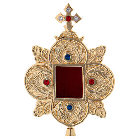 Gold plated brass reliquary with colored stones and square viewing window