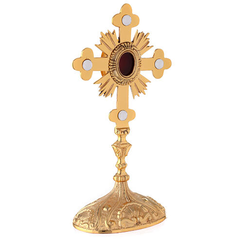 Oval reliquary with budded cross and rays gold plated brass 11 in 5