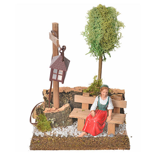 Nativity setting, woman sitting on bench with lamp 1