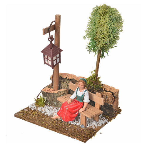 Nativity setting, woman sitting on bench with lamp 2