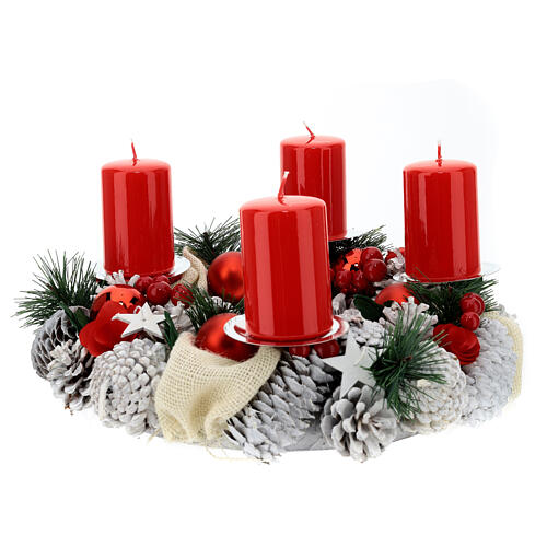 Snowy advent wreath with red berries and red candles 1