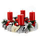 Snowy advent wreath with red berries and red candles s1