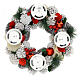 Snowy advent wreath with red berries and red candles s2