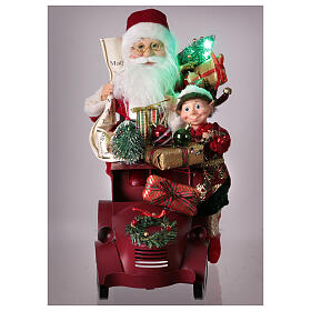 Papá Noel en trineo con regalo luces movimientos 40x40x20 cm