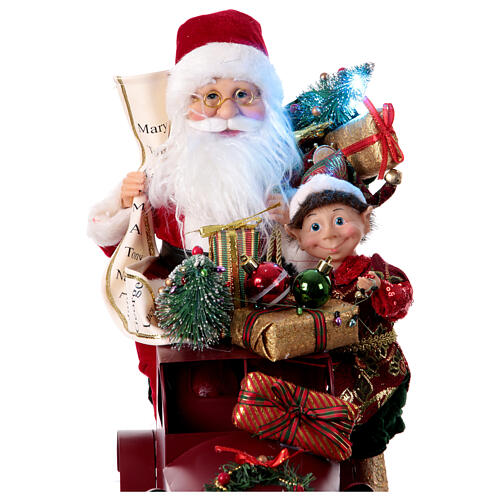 Papá Noel en trineo con regalo luces movimientos 40x40x20 cm 3