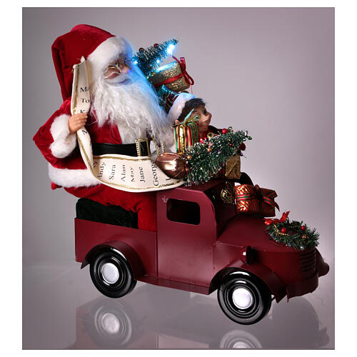 Papá Noel en trineo con regalo luces movimientos 40x40x20 cm 5