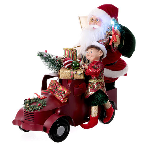 Papá Noel en trineo con regalo luces movimientos 40x40x20 cm 7