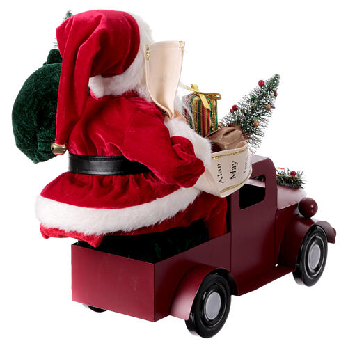 Papá Noel en trineo con regalo luces movimientos 40x40x20 cm 9