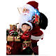 Père Noël en traineau avec cadeaux lumières mouvement 40x40x20 cm s6