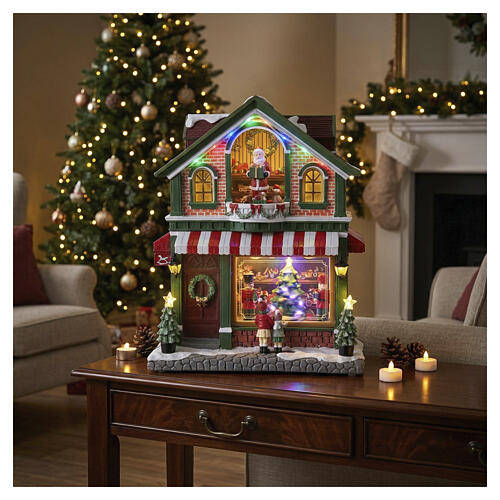 Pueblo tienda de juguetes navideño animado LED 40x35x20 cm 2