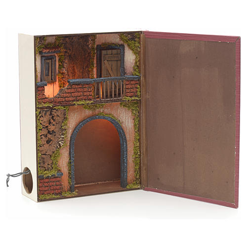 Illuminated village with balcony for nativities inside a book 30 1