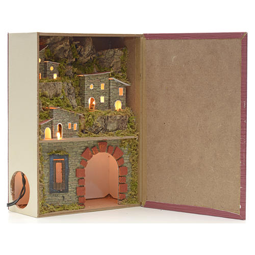 Illuminated village with grotto for nativities inside a book 24x 1