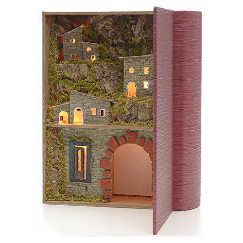 Illuminated village with grotto for nativities inside a book 24x 2