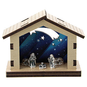 Nativity in metal with wood shack and printed sky in the background 5 cm