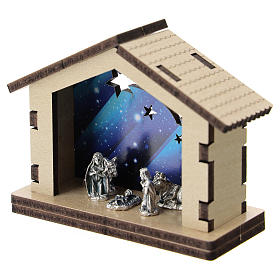 Nativity in metal with wood shack and printed sky in the background 5 cm