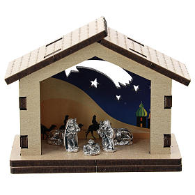 Nativity in metal with wood shack and printed desert in the background 5 cm