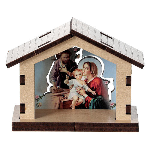 Häuschen aus Holz mit einer Szene der Heiligen Familie im Hintergrund 1