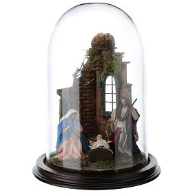 Neapolitan nativity scene on a wooden base with a glass domed roof