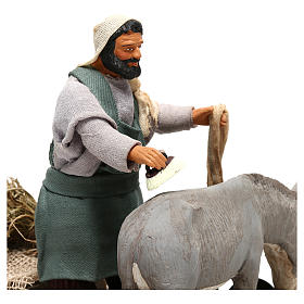 Man currying donkey  in movement 14 cm for Neapolitan nativity scene