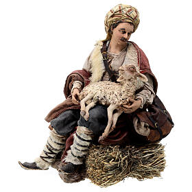 Shepherd sitting with a sheep for terracotta Angela Tripi's Nativity Scene of 30 cm