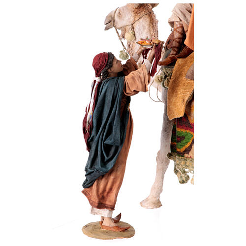 Shepherd on a camel with woman offering him food for terracotta Angela Tripi's Nativity Scene of 30 cm 12
