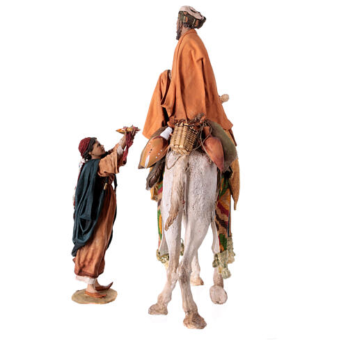 Shepherd on a camel with woman offering him food for terracotta Angela Tripi's Nativity Scene of 30 cm 15