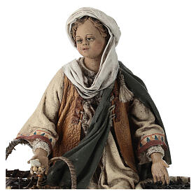 Young man on his knees with baskets, Angela Tripi's Nativity Scene of 13 cm