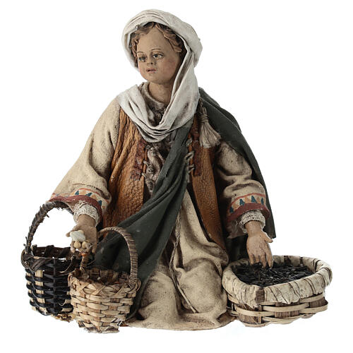 Young man on his knees with baskets, Angela Tripi's Nativity Scene of 13 cm 1