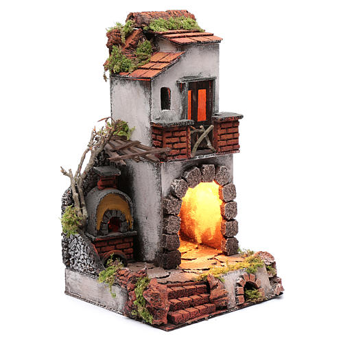 Neapolitan nativity scene setting composed by house with chimney and lights 3