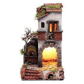 Neapolitan nativity scene setting composed by house with chimney and lights