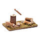 Woodcutter and trunks on a grass field base nativity scene accessories 5x10x5 cm s2