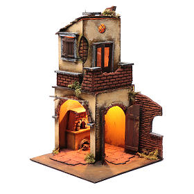 Nativity scene setting double arched house with light and fireplace